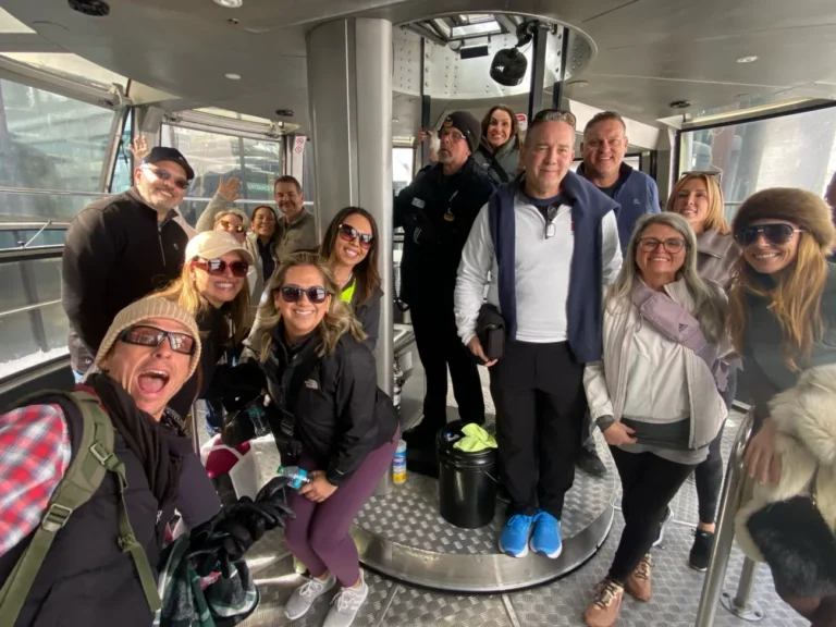 Guests smiling and posing inside of the tram.