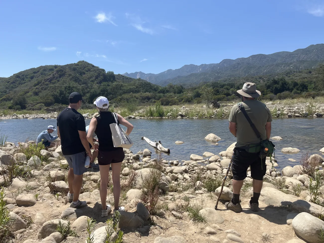 Guests standing on a rivers edge on the Ojai hiking tour