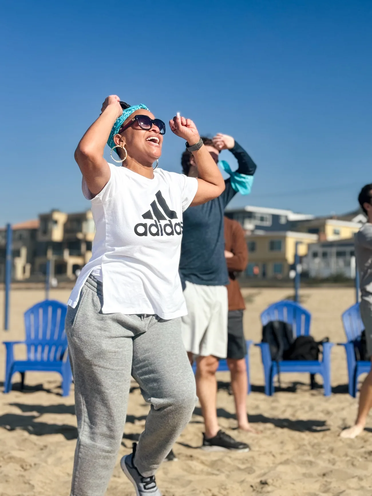 A woman celebrates while playing cornhole
