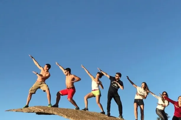 Guests pose on a rock in San Diego