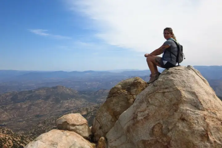 A guest stares at the view at the top of a mountain