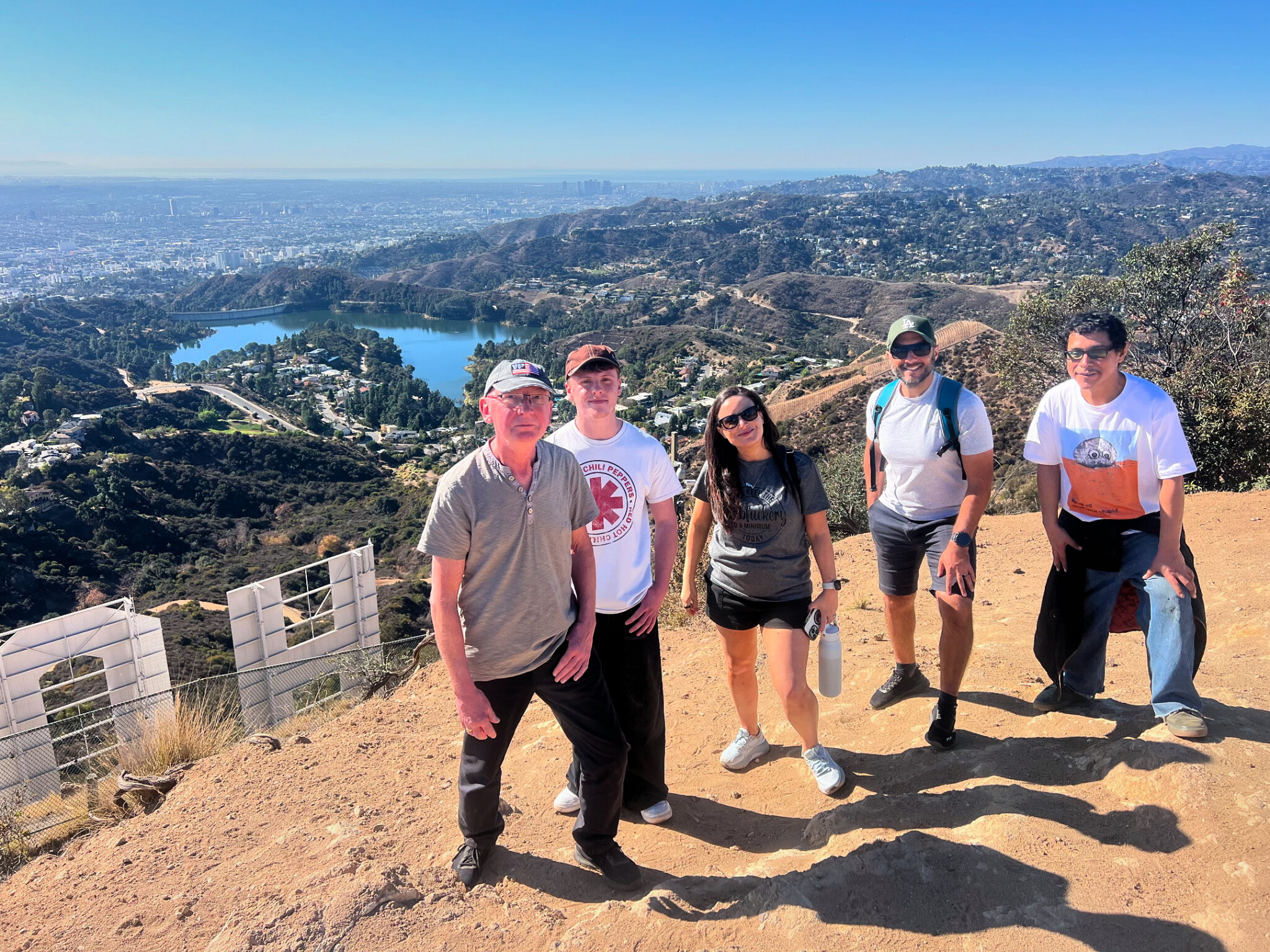 A group stands behind the Hollywood Sign on our Hollywood Sign Tour