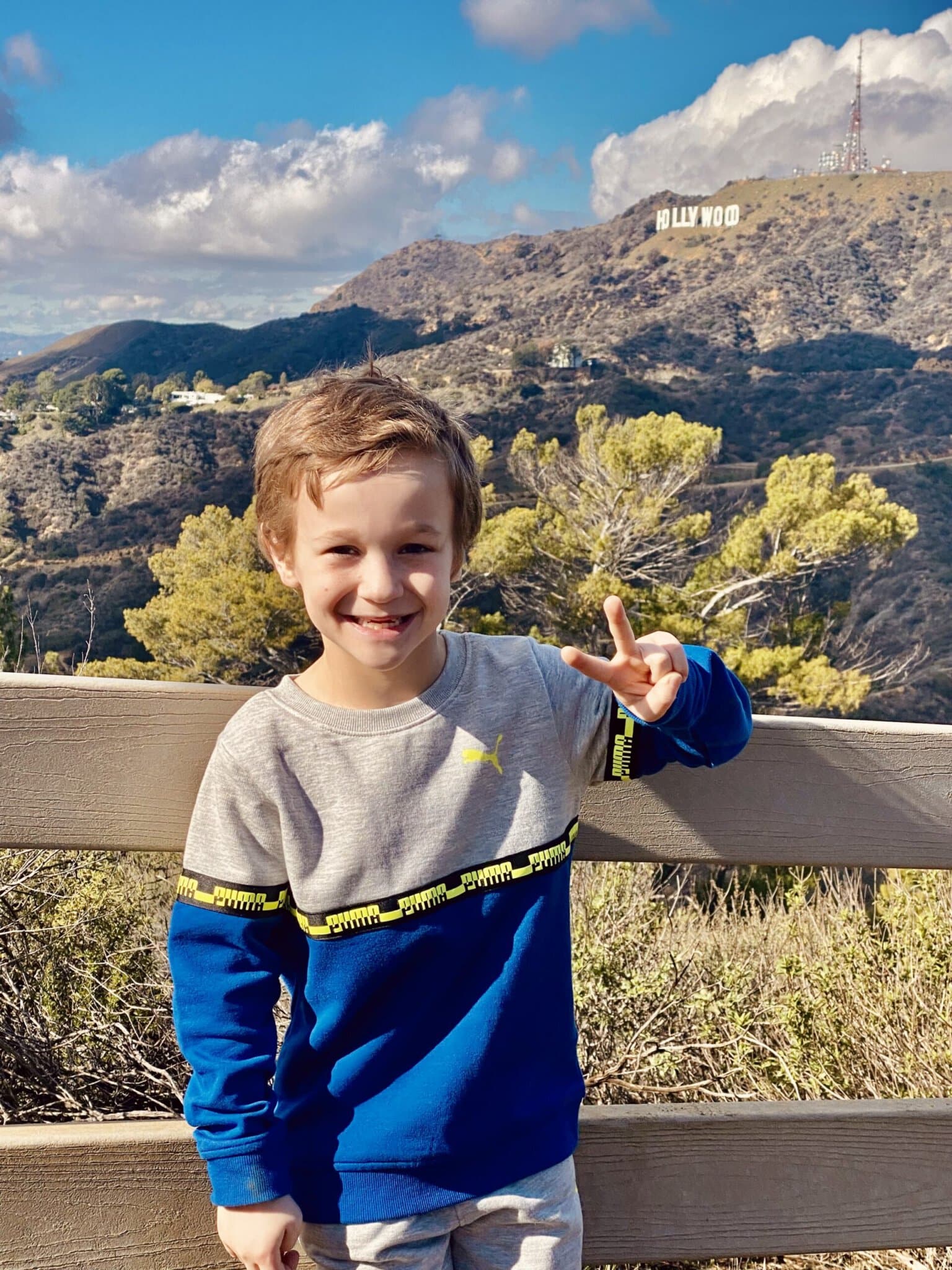 A little boy with the hollywood sign on the Griffith Park Tour