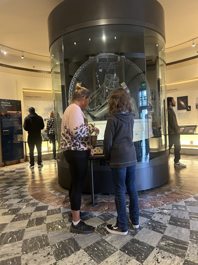 Guests on our Griffith park Tour looking around the inside of the Griffith Observatory