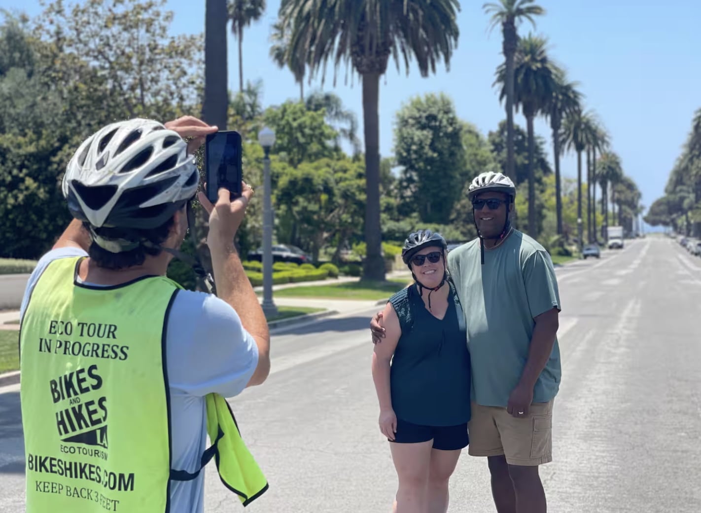 A guide takes a photo for guests on the LA in a day tour