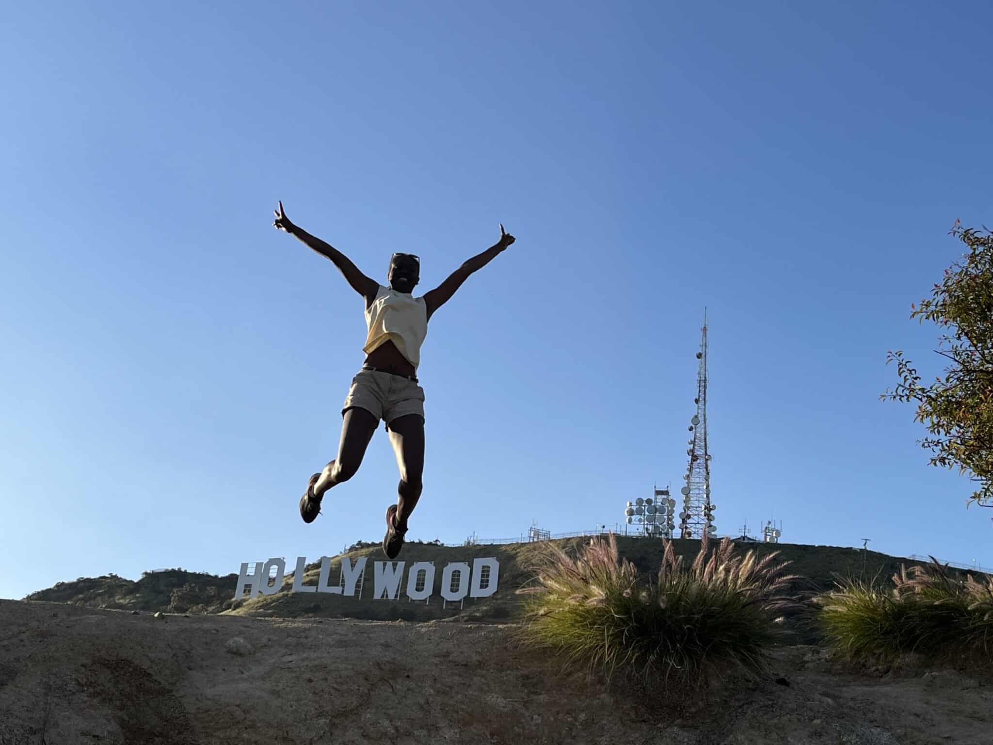 A guest jumps over the Hollywood Sign on our Hollywood Hike