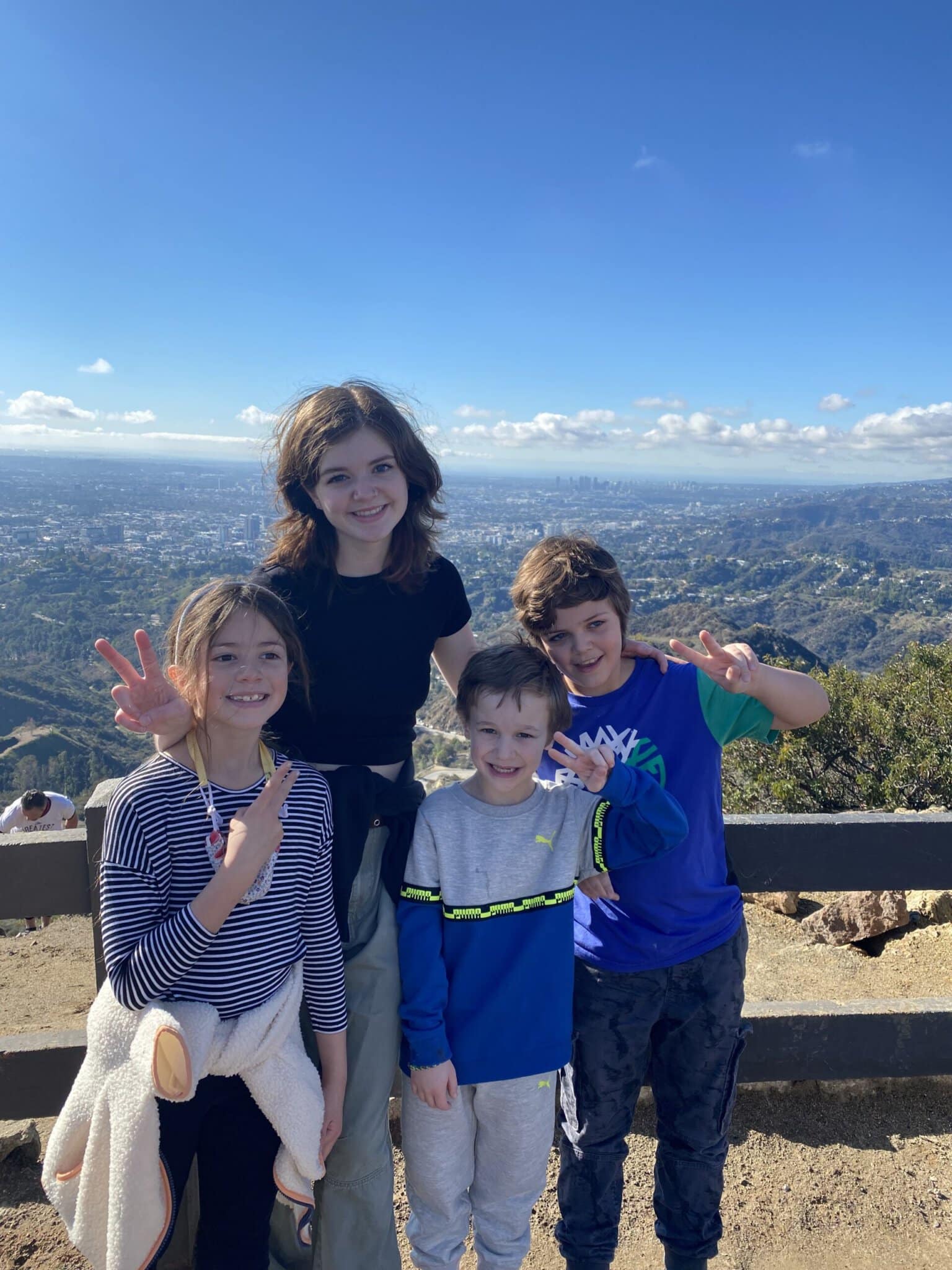 Kids smiling as they take in the views of from the Griffith Observatory Hike