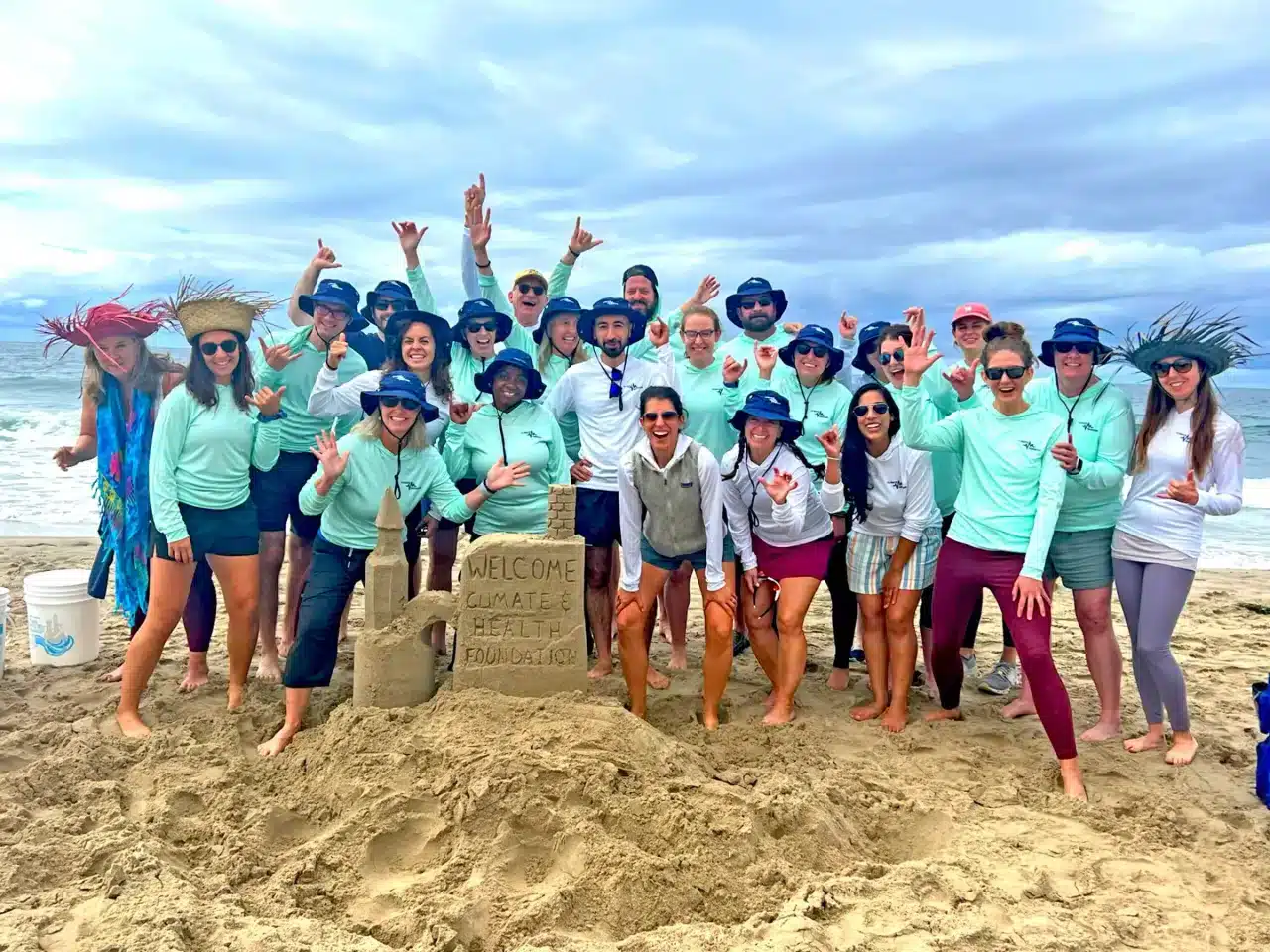 The winners of a sandcastle sculpting competition cheer