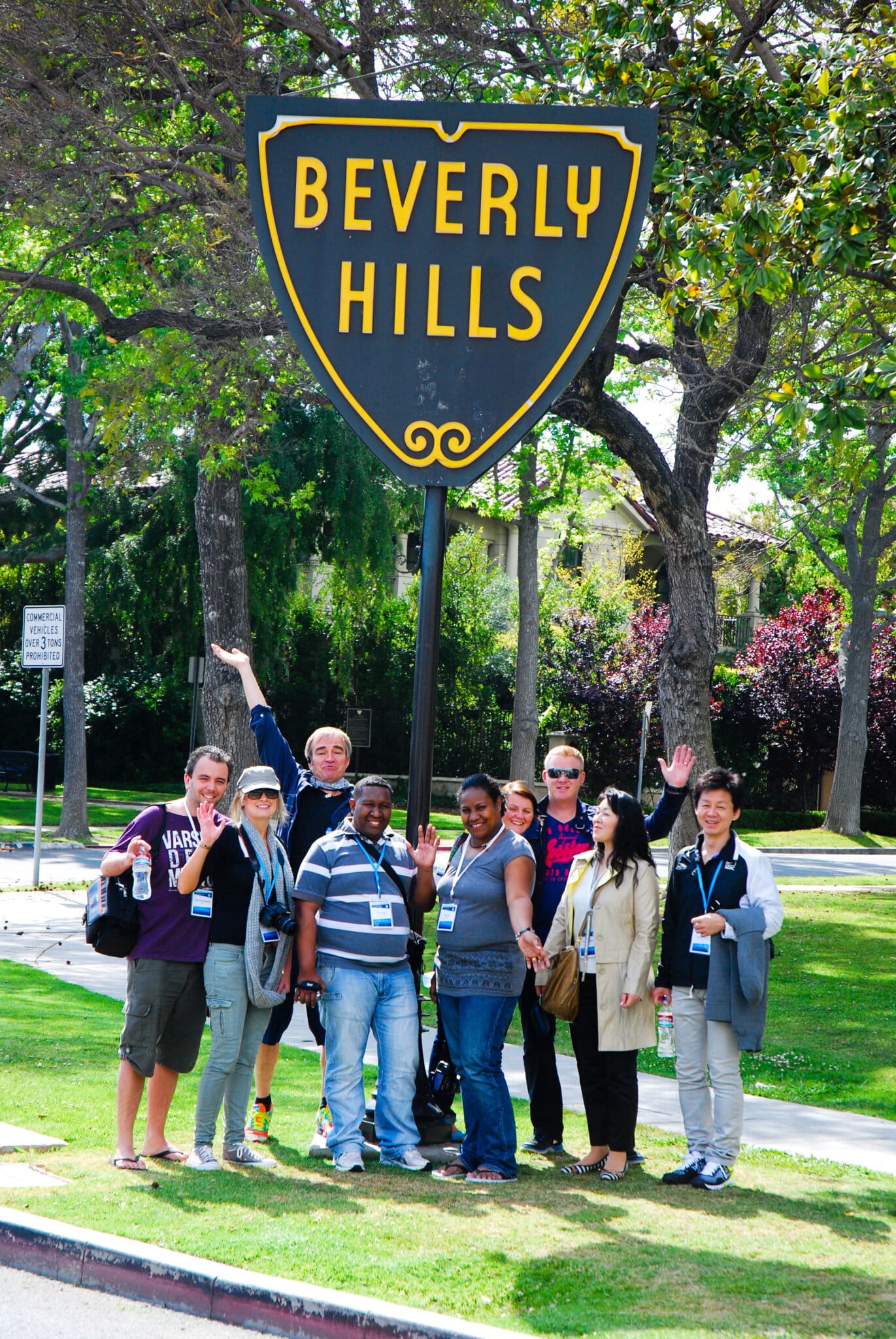 Guests pose with the Beverly Hills Sign on the Beverly Hills Walking Tour
