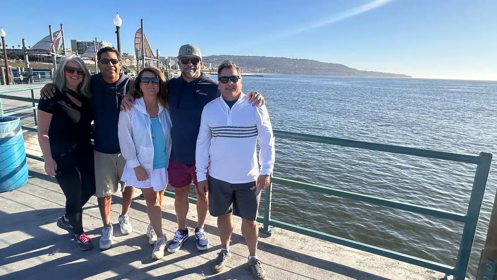 Guests pose on a pier in the South Bay