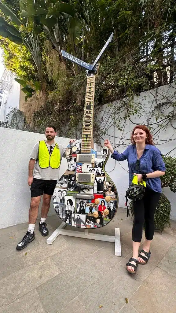 Guests pose with a cool guitar on the West Hollywood Bike Tour