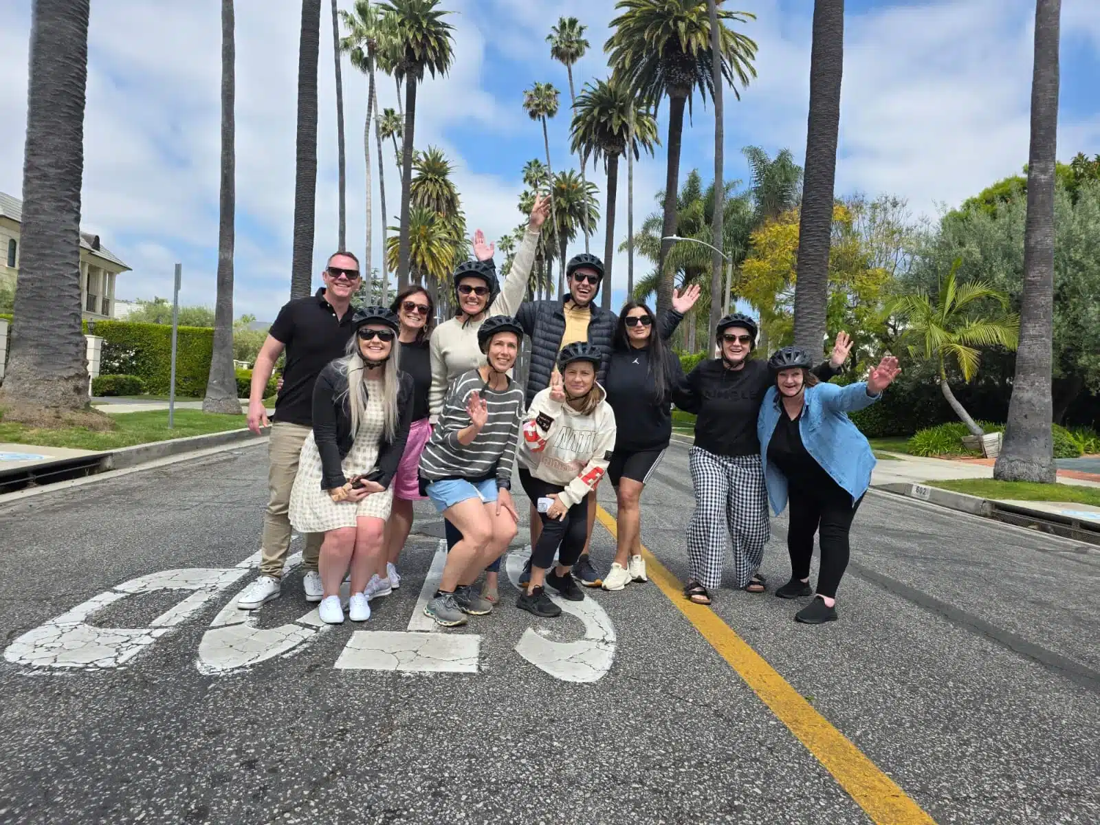 Guests in Beverly Hills on a palm lined street on the Beverly Hills Tour
