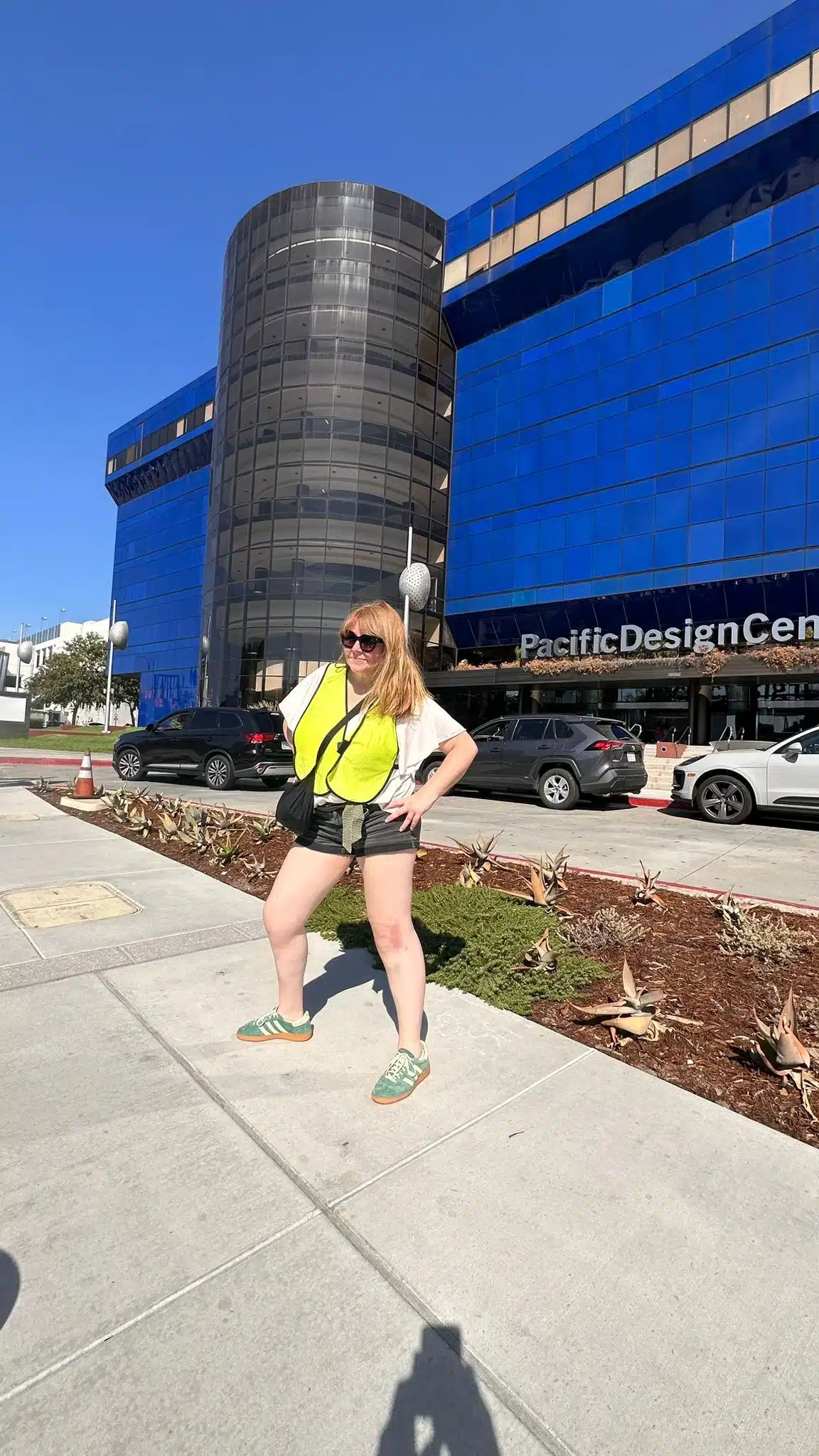 Smiling and pointing in front of the Pacific Design Center on the West Hollywood bike Tour