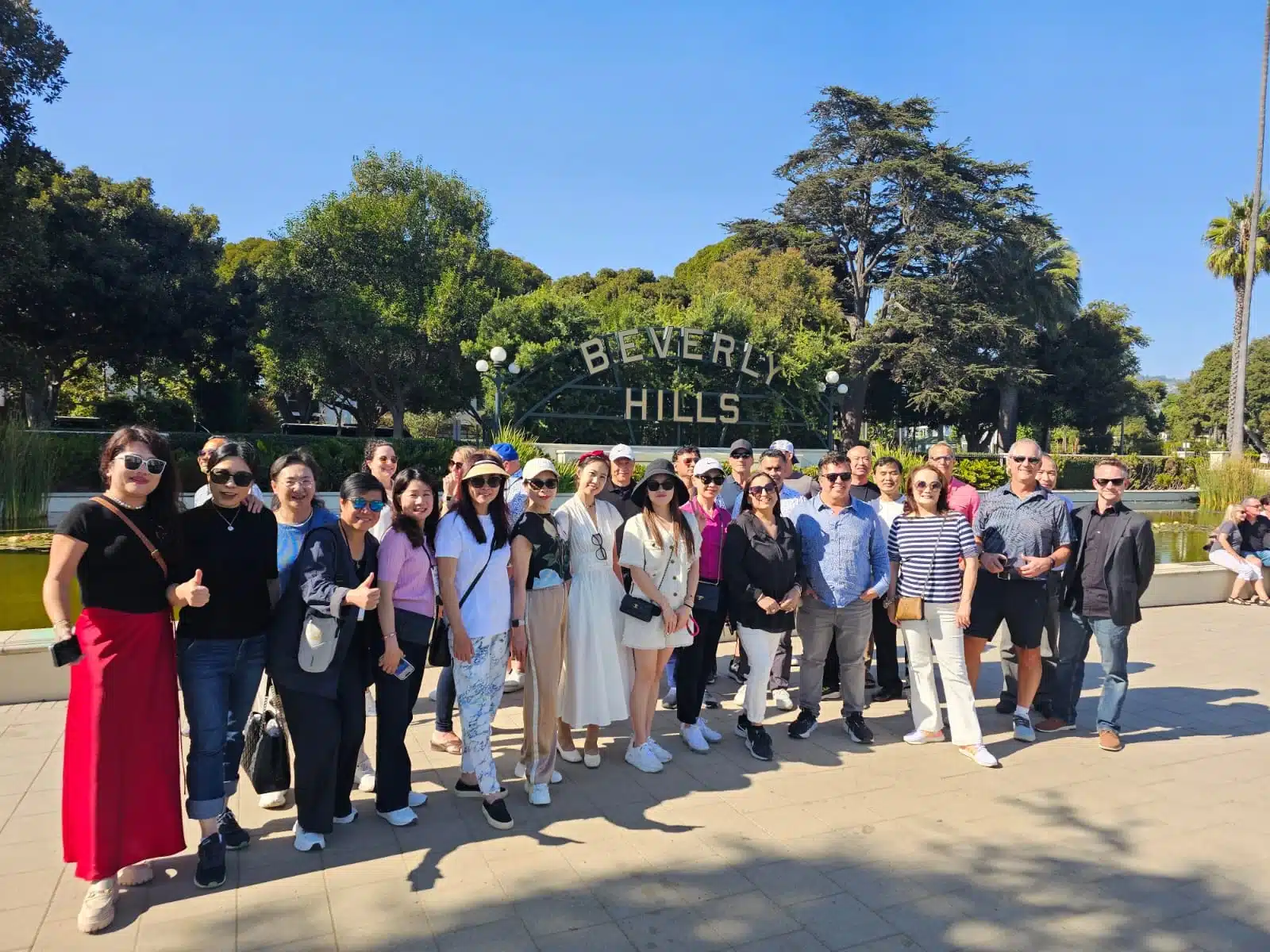 Guests in front of the Beverly Hills Sign on the Group Beverly Hills Bike Tour