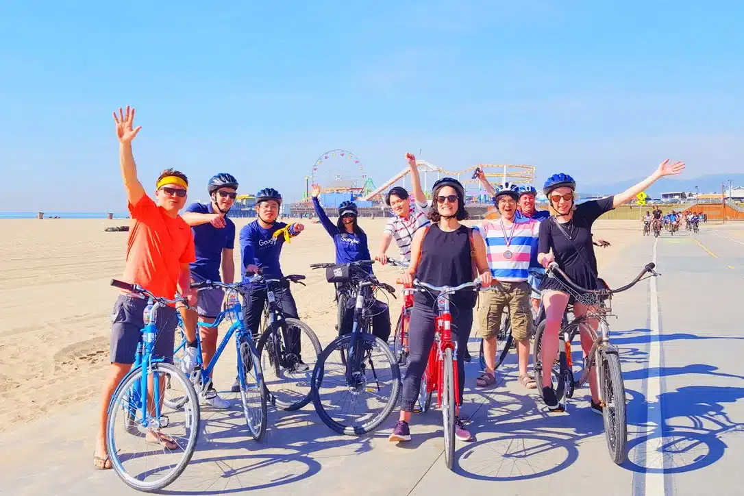 Guests pumping their fists in the air on the santa monica and venice beach bike tour