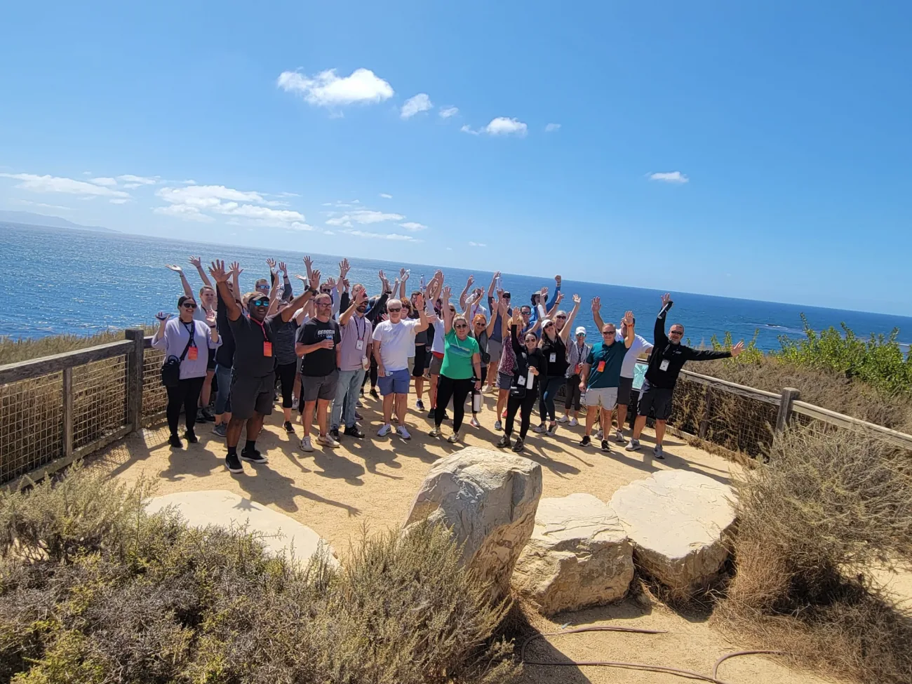 Corporate group celebrating on a scenic coastal overlook during a guided nature walk in Palos Verdes near Terranea Resort