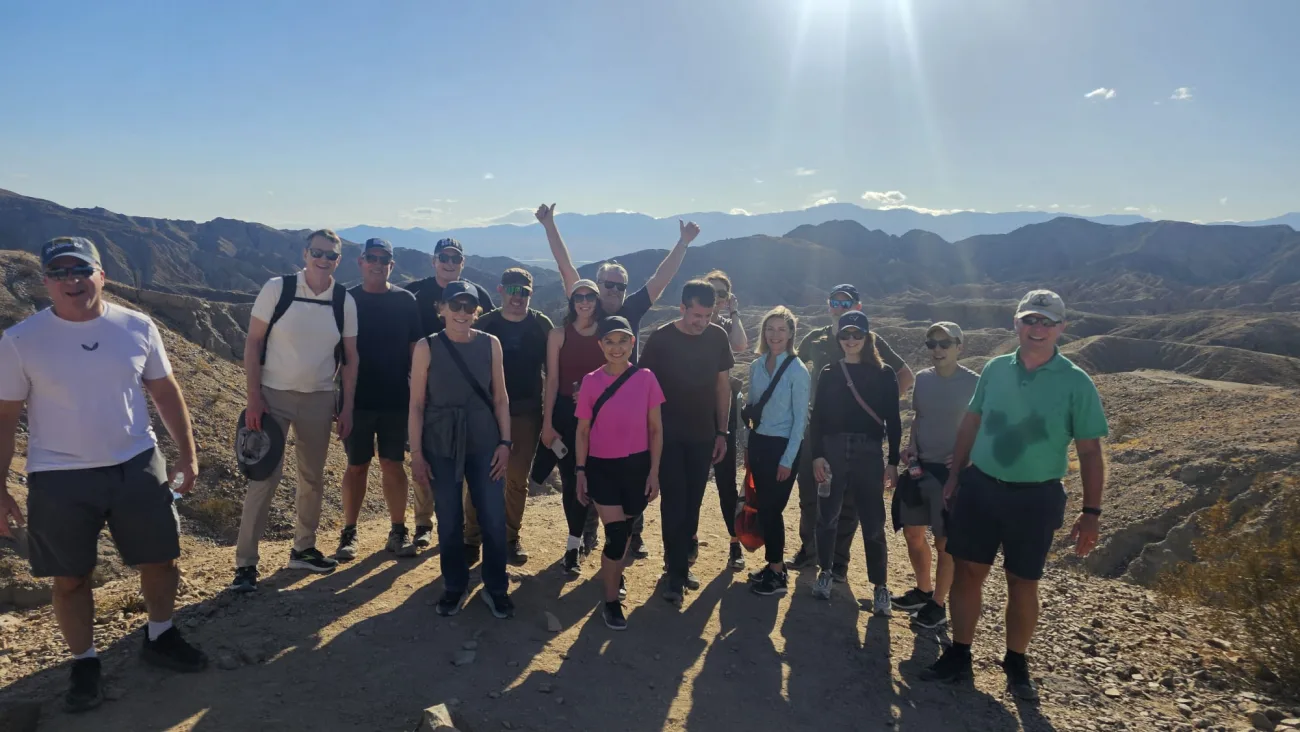 A group smiles at the completion of their hike