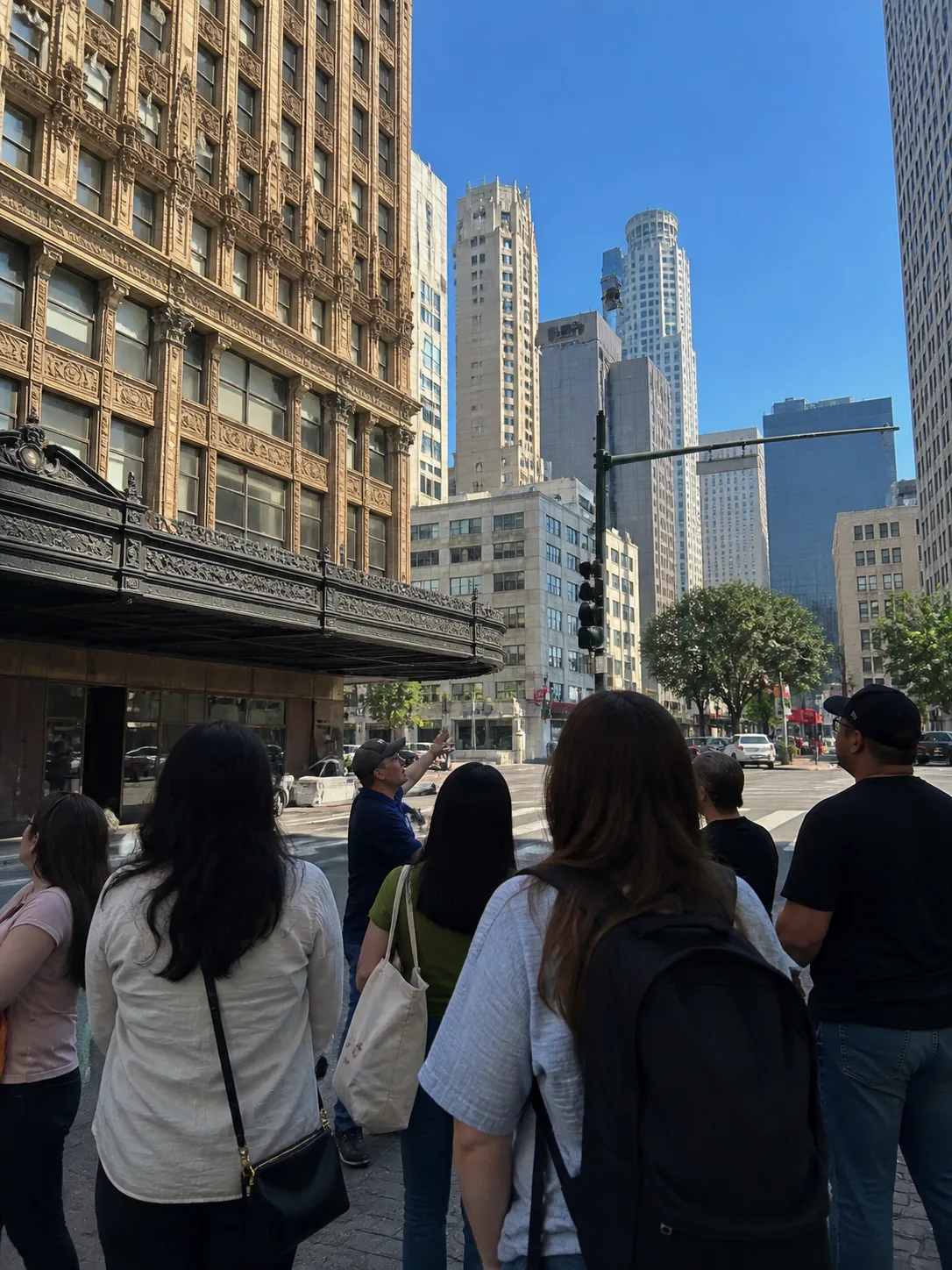Guests listen to their tour guide speak in downtown Los Angeles