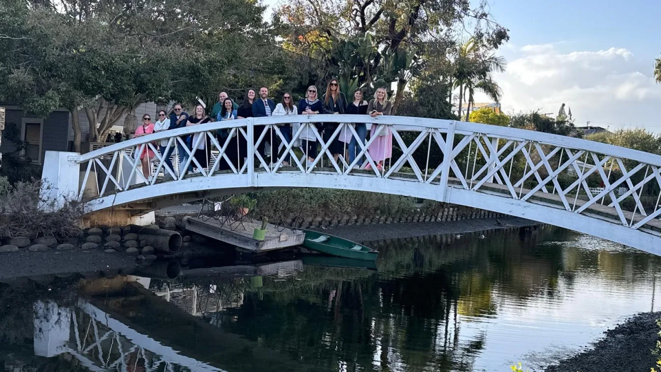 Guests pose on a bridge in the Venice Canals