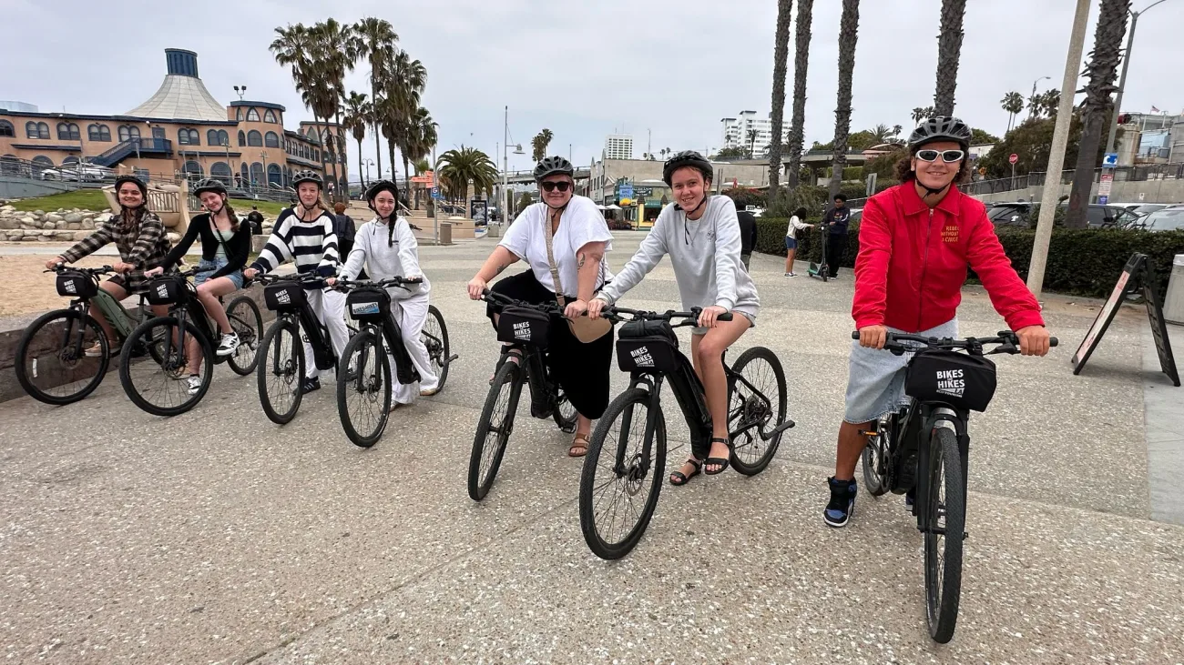 Guests pose in Santa Monica on bikes
