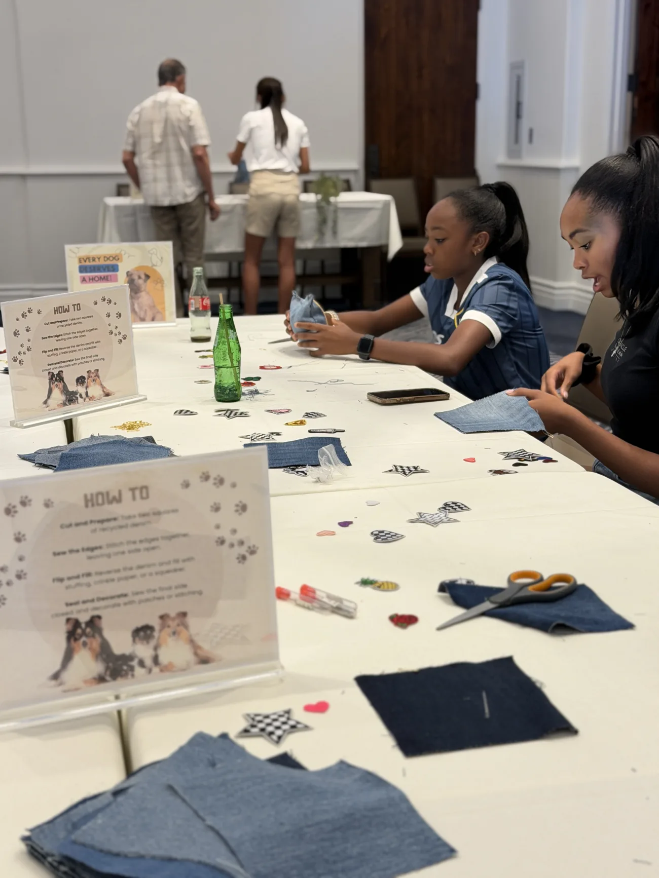 Guests participating in recycled dog toy making