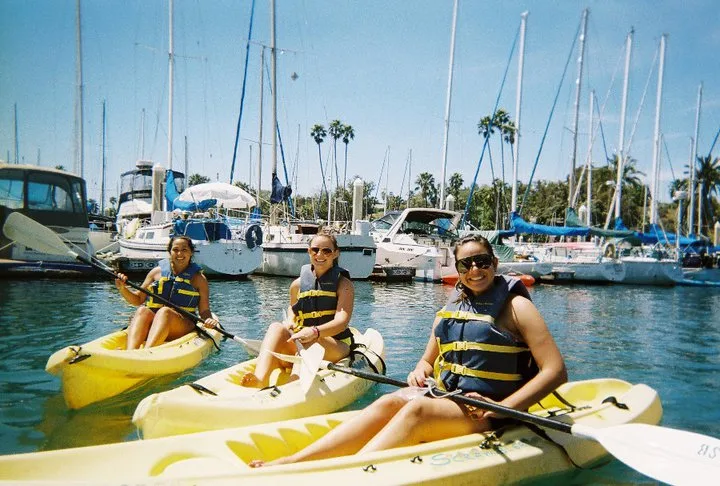 Guests smiling on kayaks in Santa Barbara