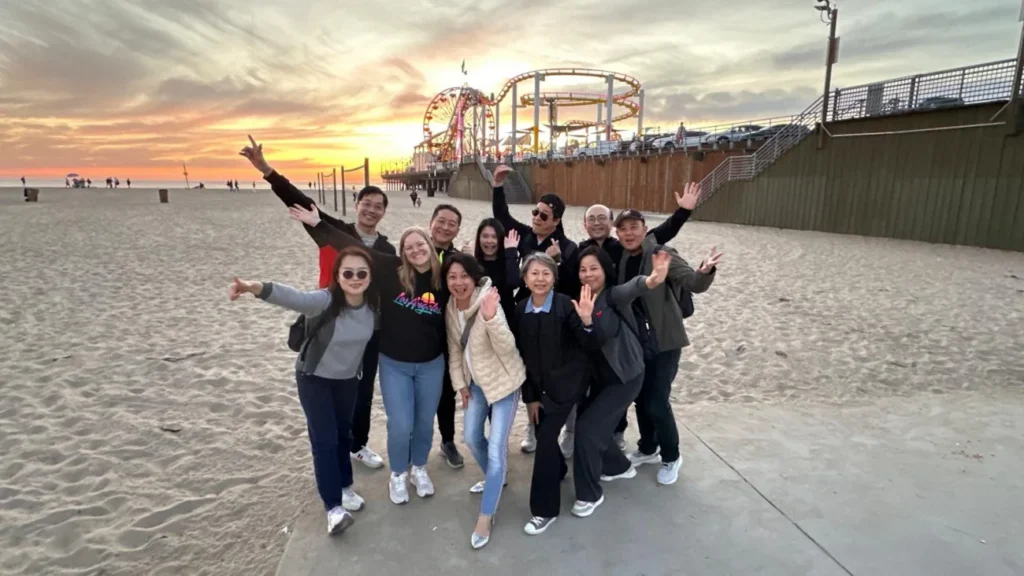 Guests posing with the Santa Monica pier at Sunset