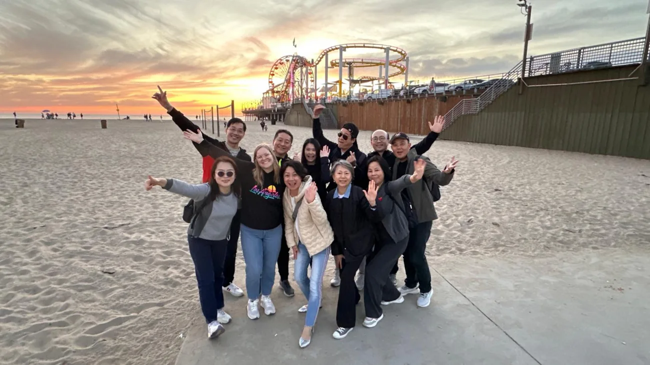 Guests posing with the Santa Monica pier at Sunset