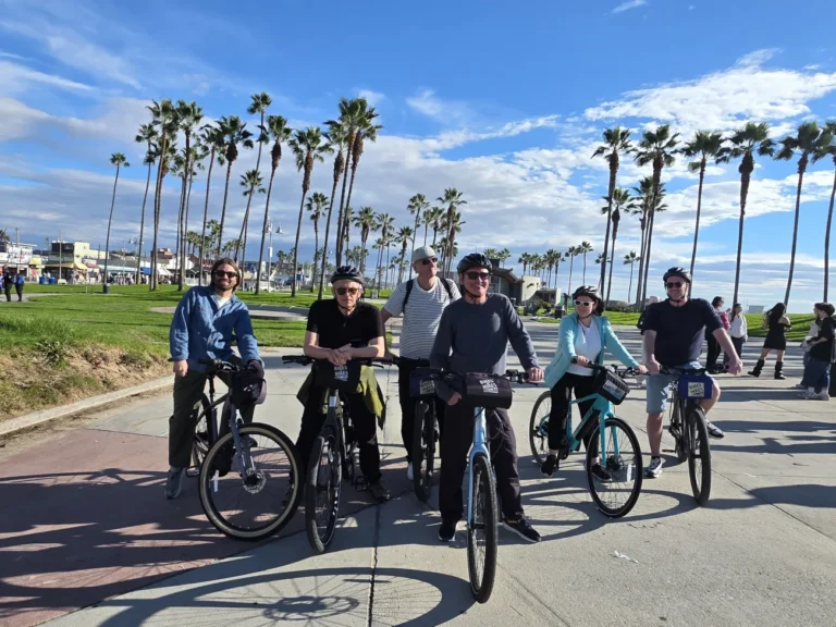 A group of guests pose on their bikes on the Santa Monica Bike Path