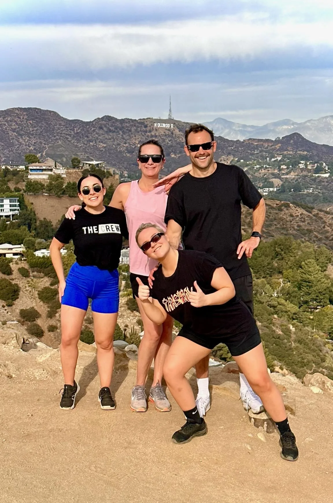 Guests pose with the Hollywood Sign at Runyon Canyon