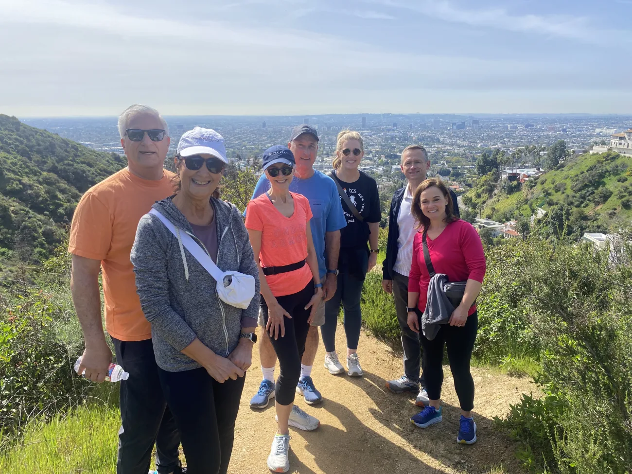 Smiling guests with greenery in the background at Runyon Canyon