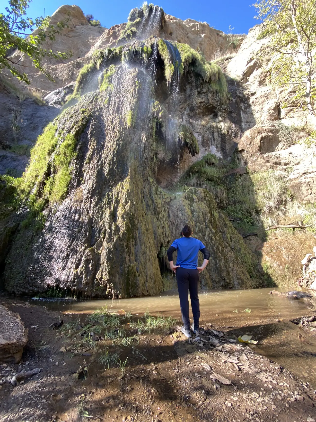A man looks at the massive Solstice Canyon Hike waterfall