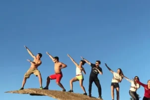 Guests pose on a rock in San Diego