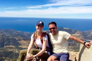 two guests sit on a peak on the Solstice Canyon Hike