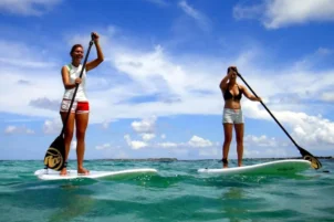 Girls on the ocean paddleboarding