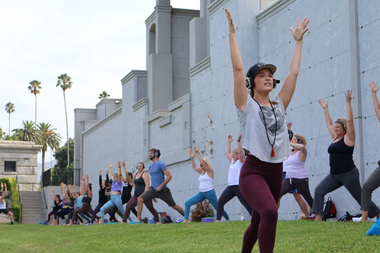 A woman leading a yoga class at Hollywood Forever Cemetery