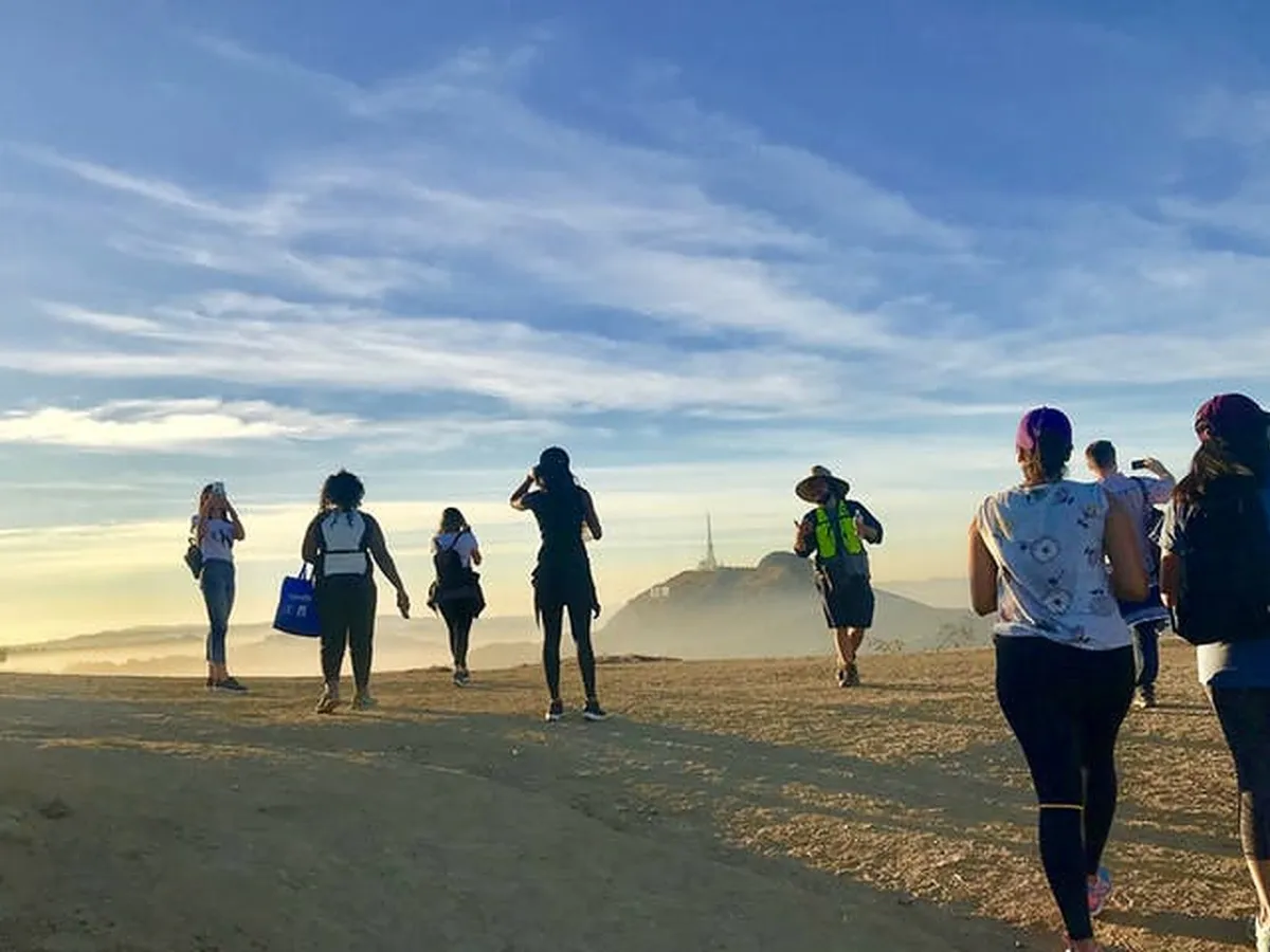 a group of people walking on a beach