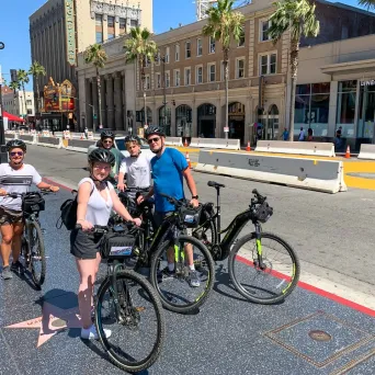 a group of people standing next to a bicycle