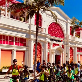 a group of people walking in front of a building