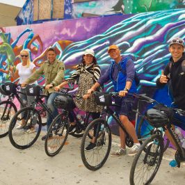 a group of people riding on the back of a bicycle