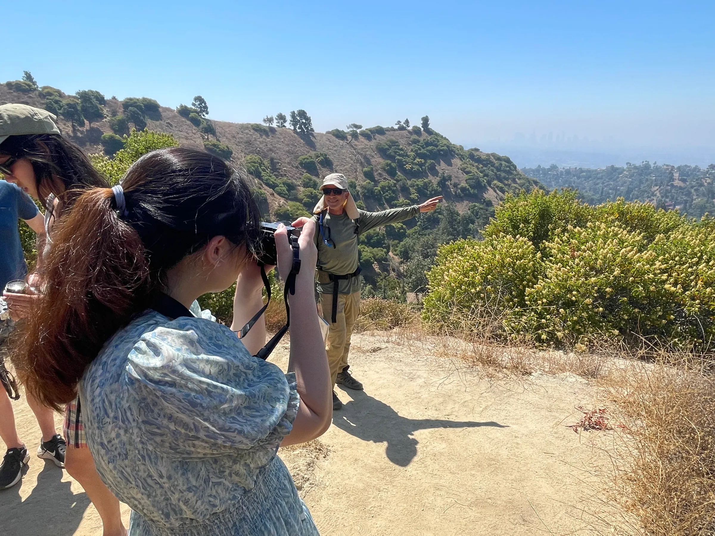 a group of people standing on top of a sandy beach