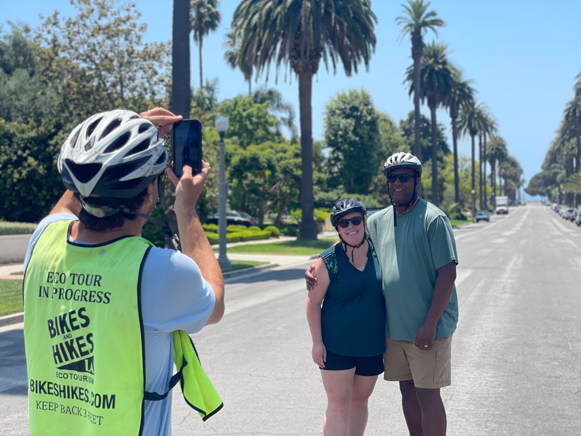 A tour guide taking a couple's photo on our Los Angeles Tour