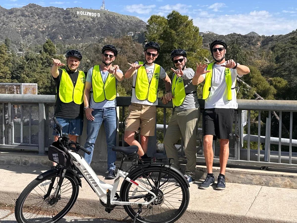 a group of people riding on the back of a bicycle