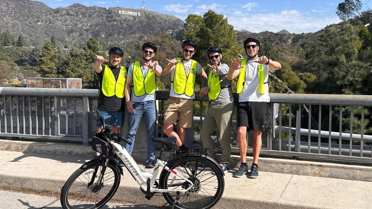 a group of people riding on the back of a bicycle