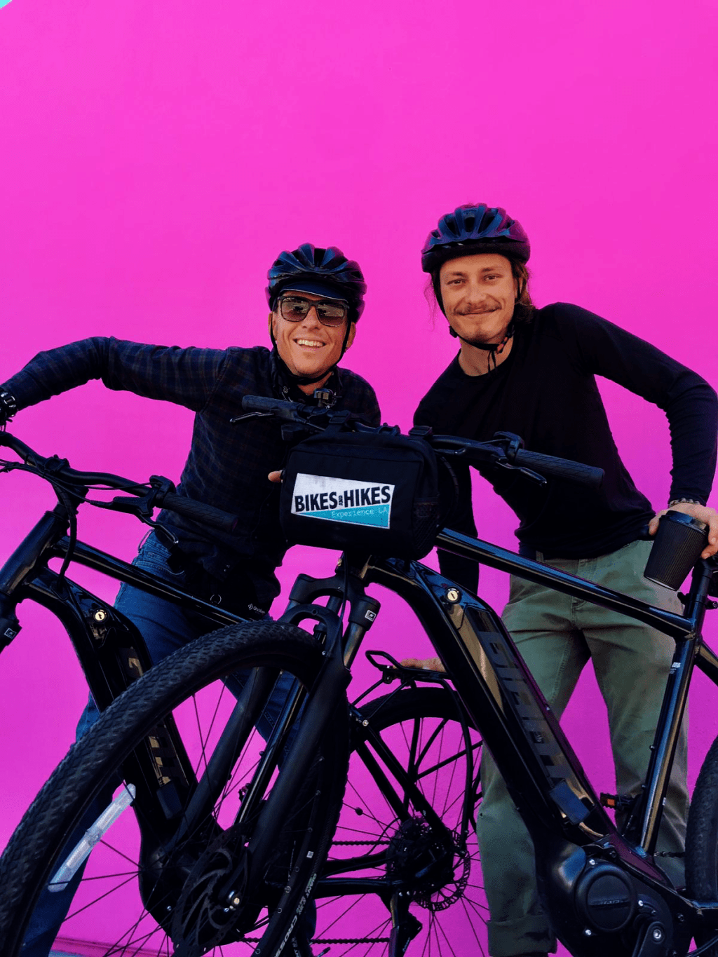 a man and a woman sitting on a bicycle