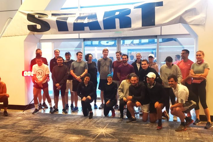 a group of people standing in front of a crowd posing for the camera