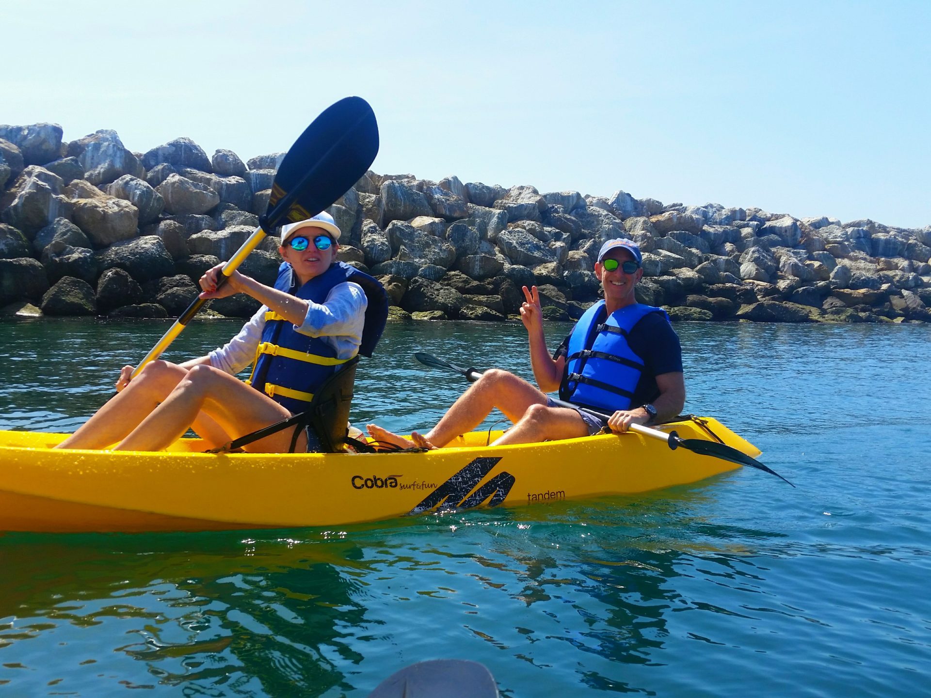 a man riding on the back of a boat in the water