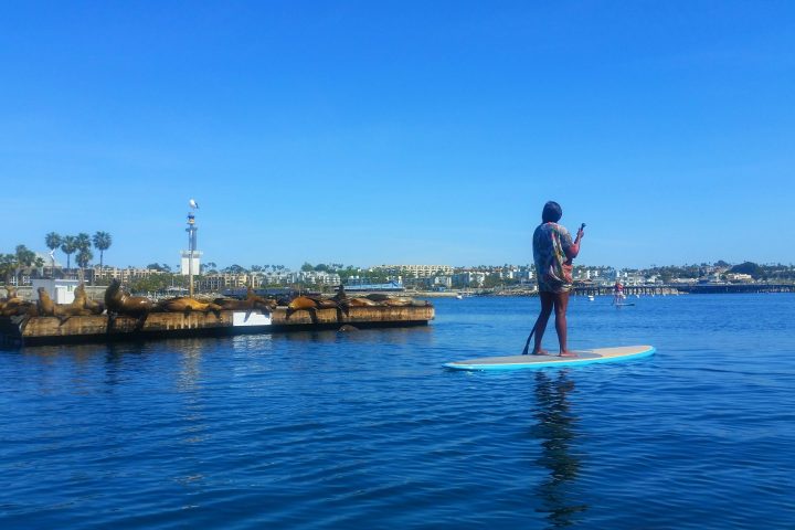 a man standing next to a body of water