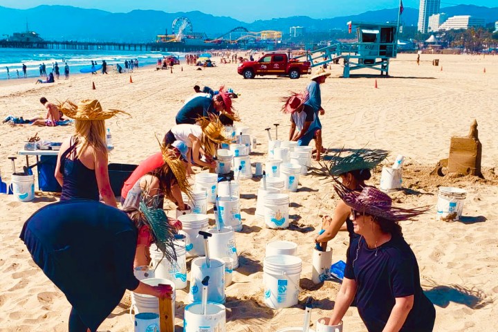 a group of people sitting at a beach