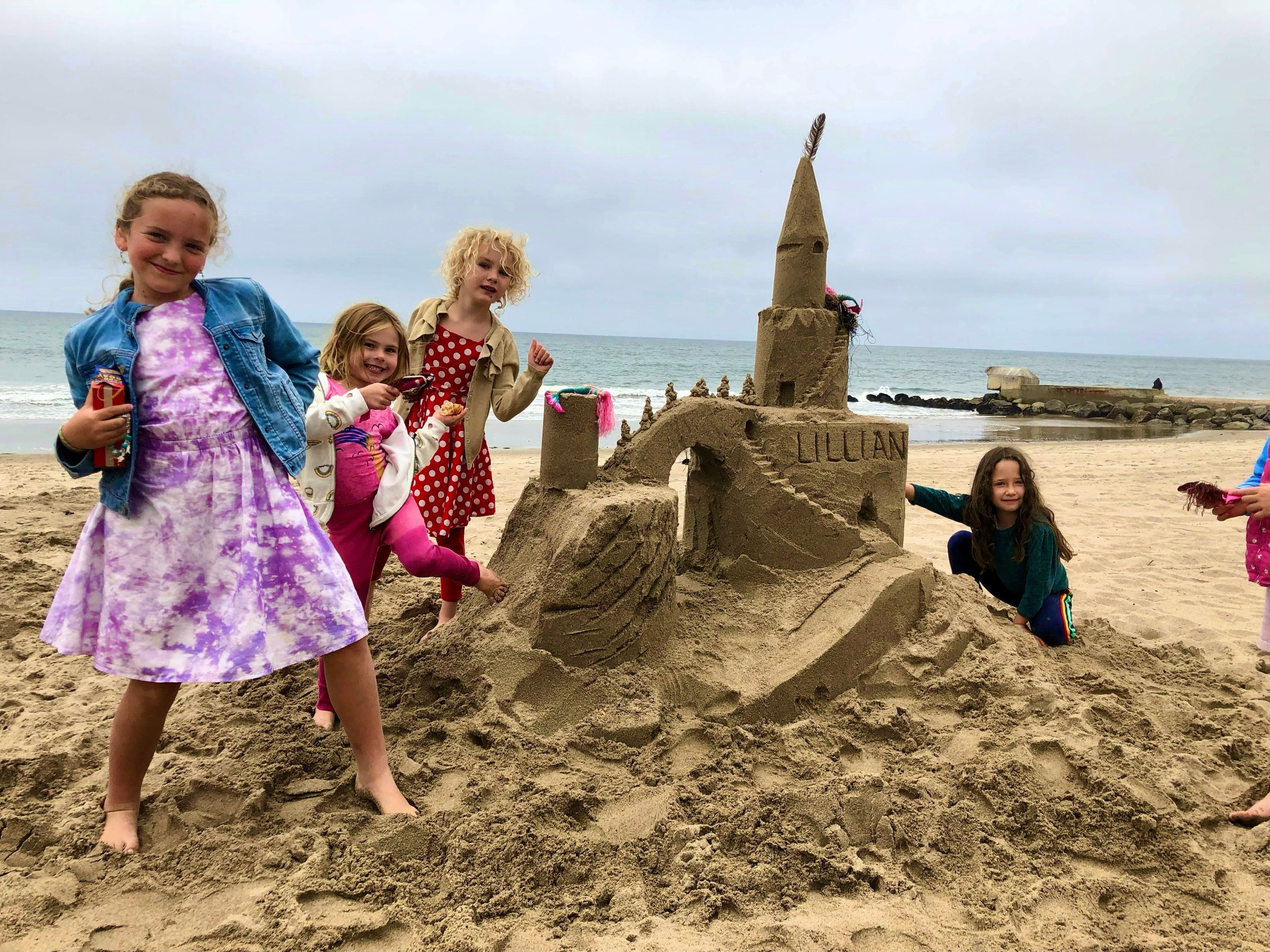 a little girl standing next to a child